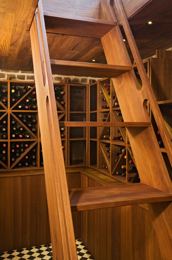 Photo of a large traditional wine cellar in Charleston with diamond bins and marble floors.