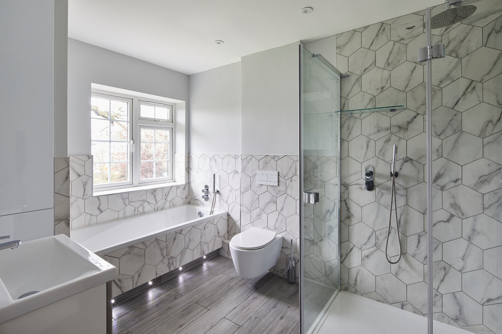 Inspiration for a contemporary bathroom in London with an alcove tub, a corner shower, white tile, white walls, a console sink, grey floor and a hinged shower door.