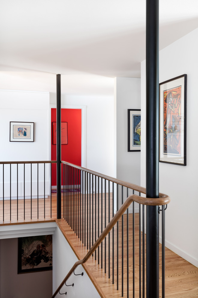 Design ideas for a mid-sized midcentury wood straight staircase in Seattle with wood risers and metal railing.