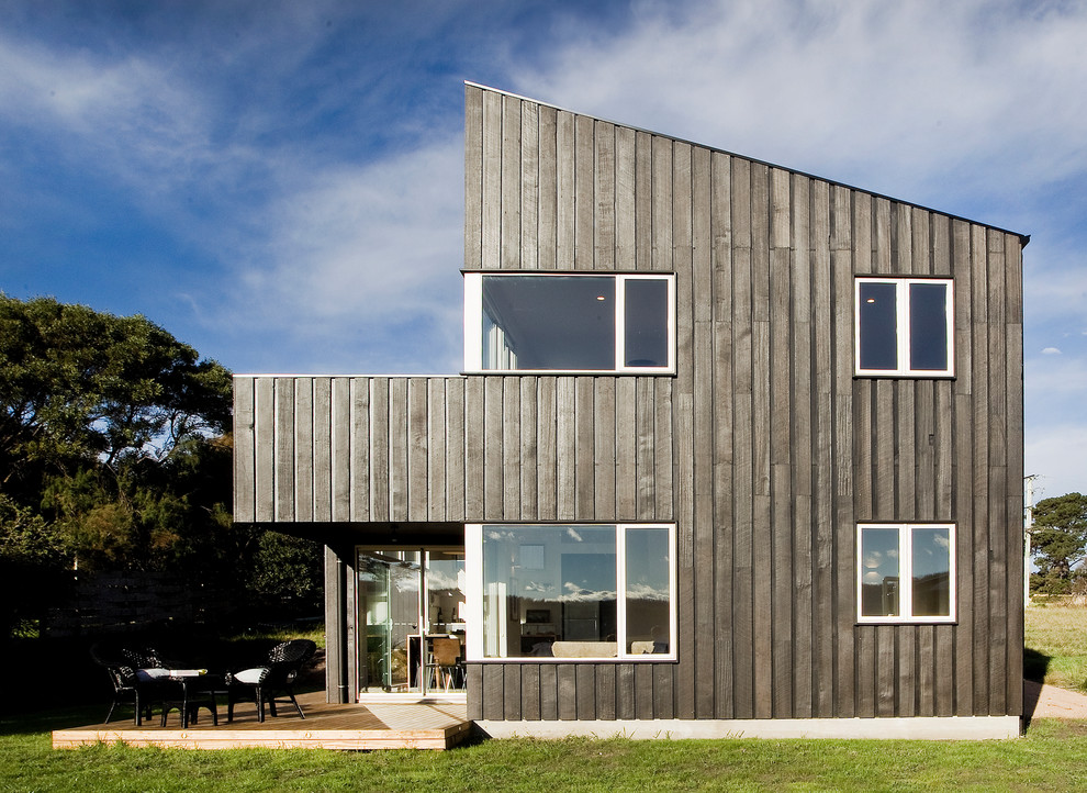 Contemporary two-storey exterior in Sydney with wood siding and a shed roof.