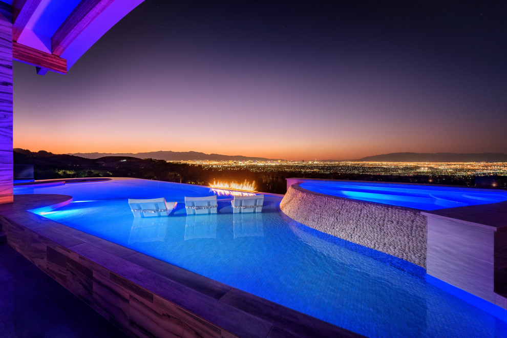 Photo of a mid-sized modern custom-shaped infinity pool in Las Vegas with tile.