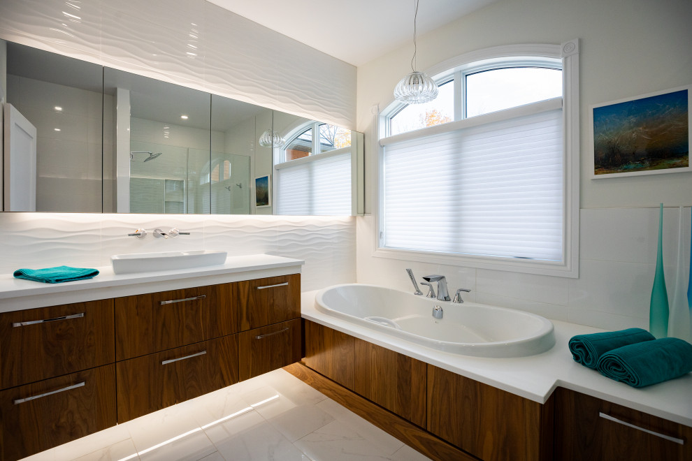 Medium sized modern ensuite bathroom in Ottawa with flat-panel cabinets, brown cabinets, a built-in bath, an alcove shower, a one-piece toilet, white tiles, white walls, porcelain flooring, a vessel sink, engineered stone worktops, white floors, a hinged door, white worktops, a single sink and a floating vanity unit.