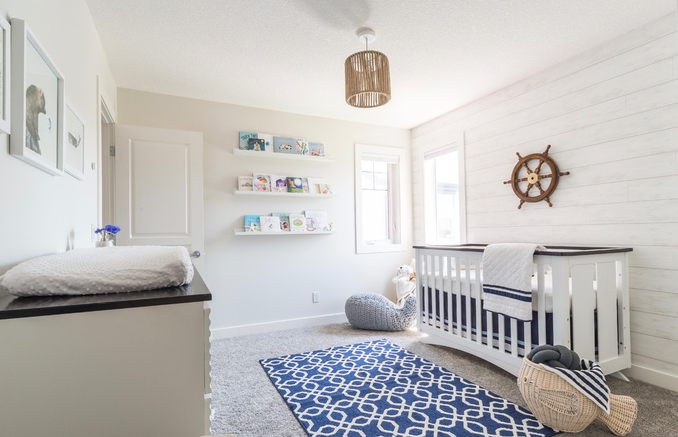 Mid-sized beach style nursery in Calgary with white walls, carpet and beige floor for boys.