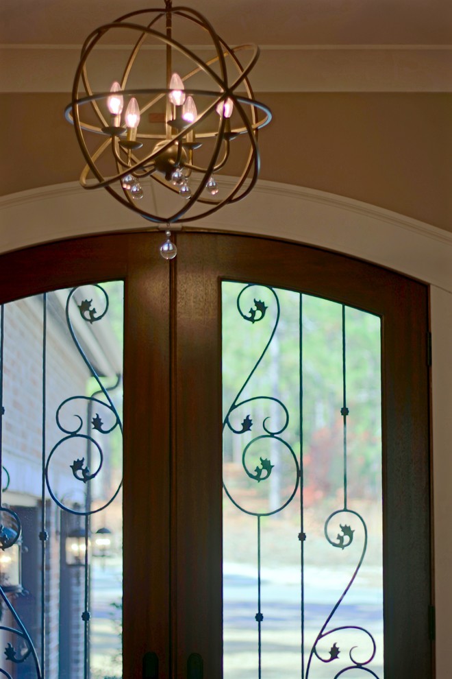 Front door - mid-sized transitional front door idea in Raleigh with beige walls and a medium wood front door