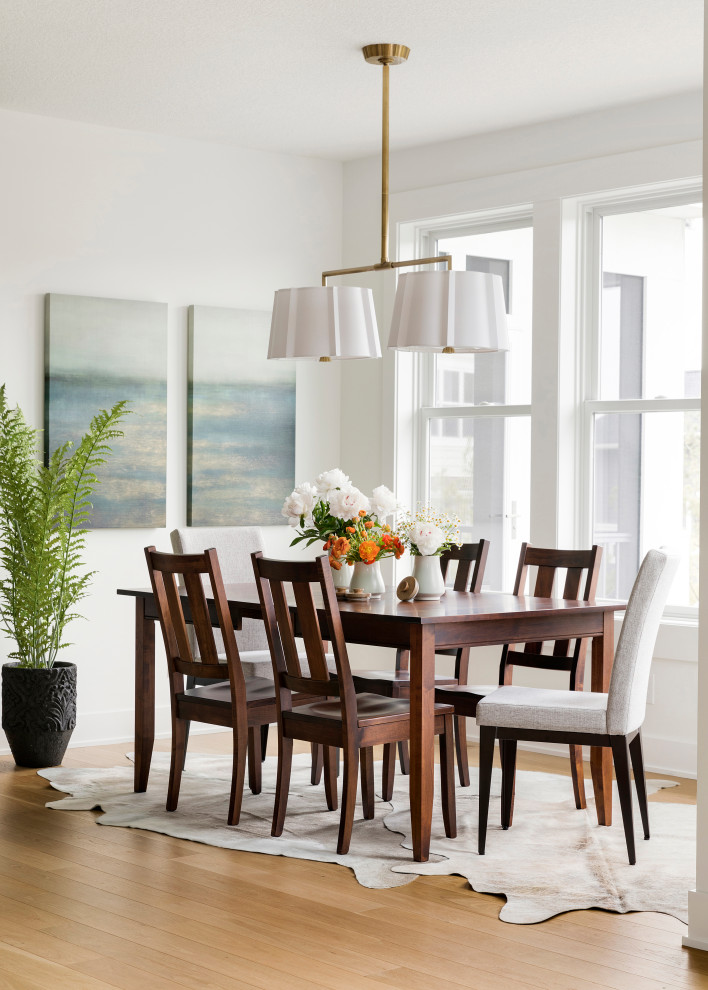 Inspiration for a mid-sized transitional open plan dining in Minneapolis with white walls and beige floor.