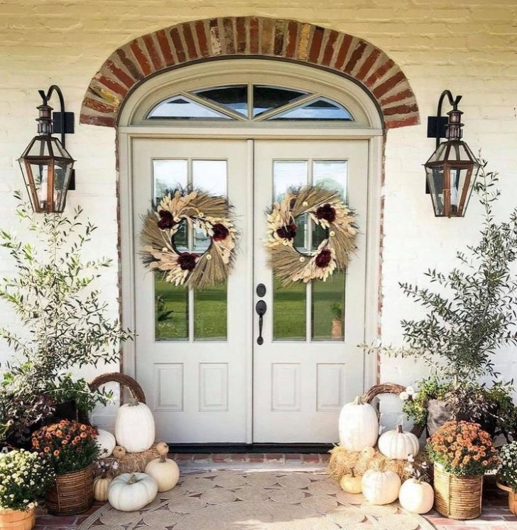 Inspiration for a traditional front door with white walls, brick floors, a double front door, a white front door, red floor and brick walls.
