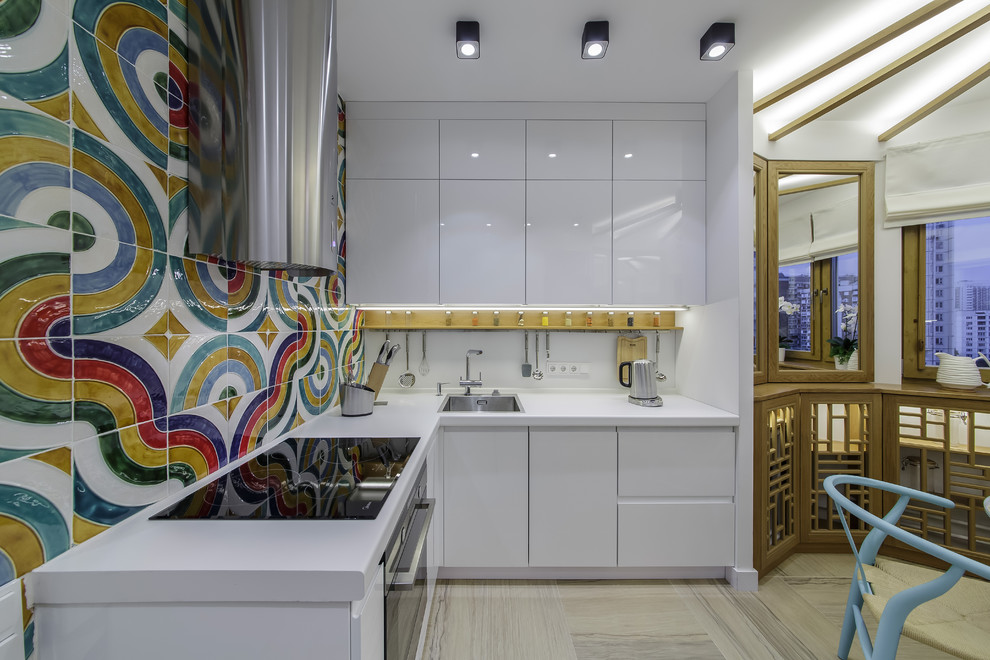 Design ideas for an eclectic l-shaped kitchen/diner in Moscow with a built-in sink, flat-panel cabinets, white cabinets, multi-coloured splashback, black appliances and no island.