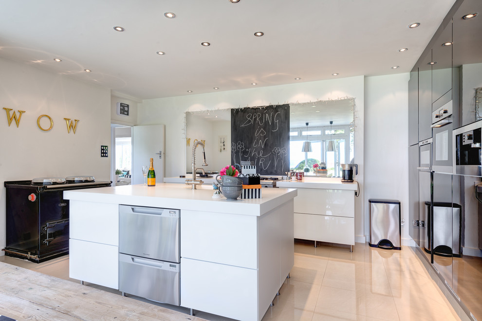 Inspiration for a large contemporary u-shaped eat-in kitchen in Devon with an integrated sink, flat-panel cabinets, white cabinets, quartz benchtops, white splashback, stainless steel appliances, ceramic floors and with island.
