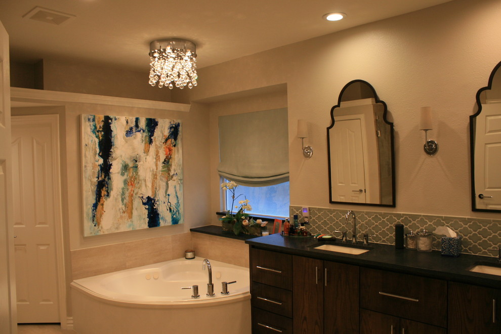 This is an example of a mid-sized contemporary bathroom in Other with an undermount sink, furniture-like cabinets, medium wood cabinets, soapstone benchtops, a drop-in tub, blue tile, ceramic tile, grey walls and ceramic floors.