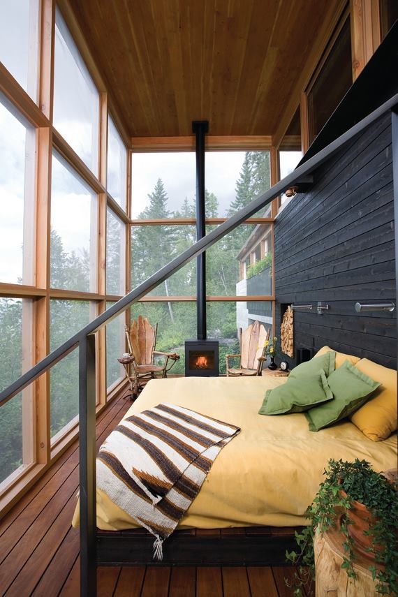 Inspiration for a country bedroom in Austin with a wood stove.