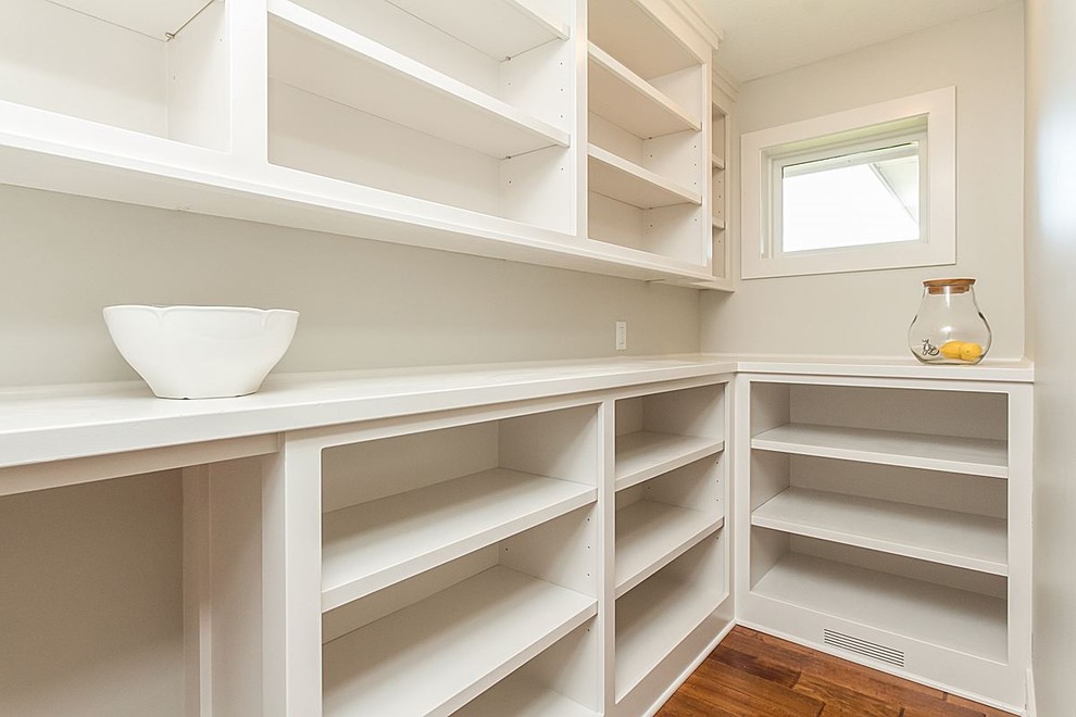 Large l-shaped medium tone wood floor and multicolored floor kitchen pantry photo with open cabinets, white cabinets, wood countertops and no island