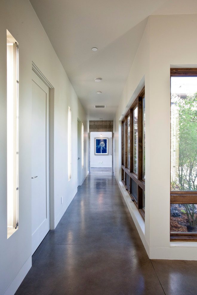 This is an example of a modern hallway in San Francisco with concrete floors and grey floor.
