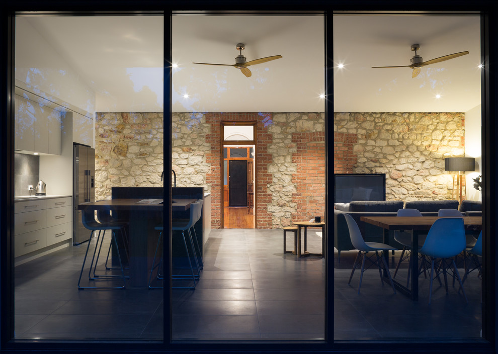 This is an example of a large contemporary open concept living room in Adelaide with porcelain floors and no fireplace.