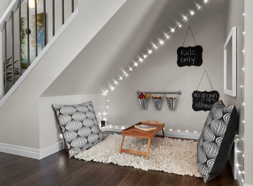 Inspiration for a small transitional gender-neutral kids' playroom for kids 4-10 years old in Edmonton with beige walls and dark hardwood floors.