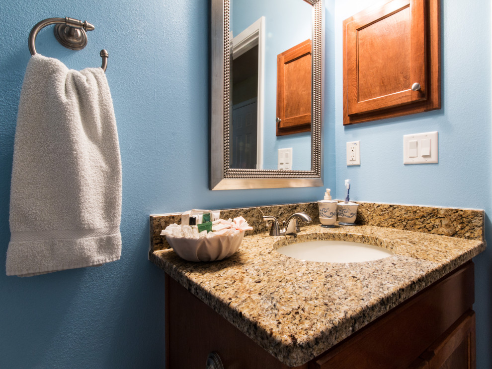 Inspiration for a mid-sized single-sink bathroom remodel with raised-panel cabinets and a built-in vanity