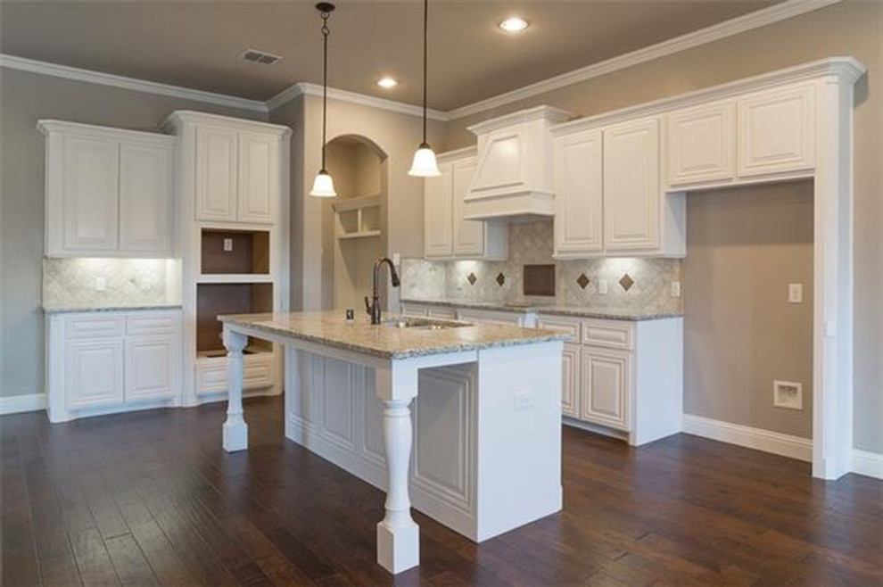 Large transitional l-shaped dark wood floor open concept kitchen photo with raised-panel cabinets, white cabinets, beige backsplash, colored appliances, an island and a double-bowl sink