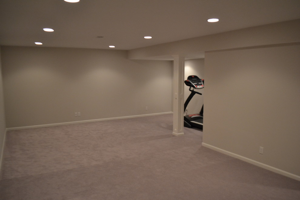 Inspiration for a large contemporary fully buried basement in Kansas City with grey walls, carpet and no fireplace.