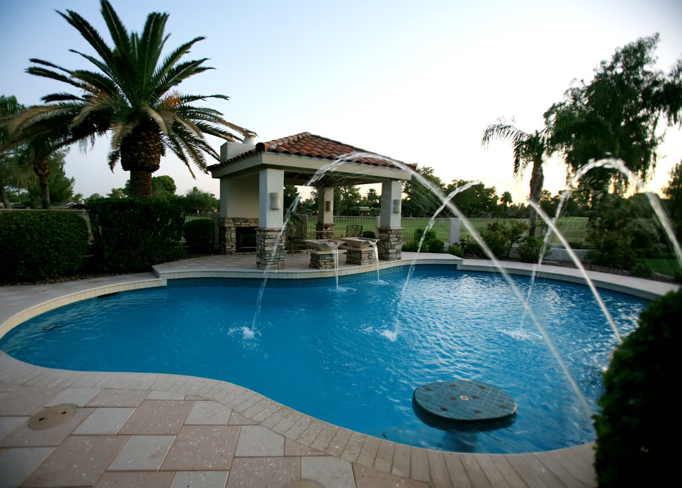 Inspiration for a mid-sized transitional backyard custom-shaped natural pool house remodel in Phoenix with decking