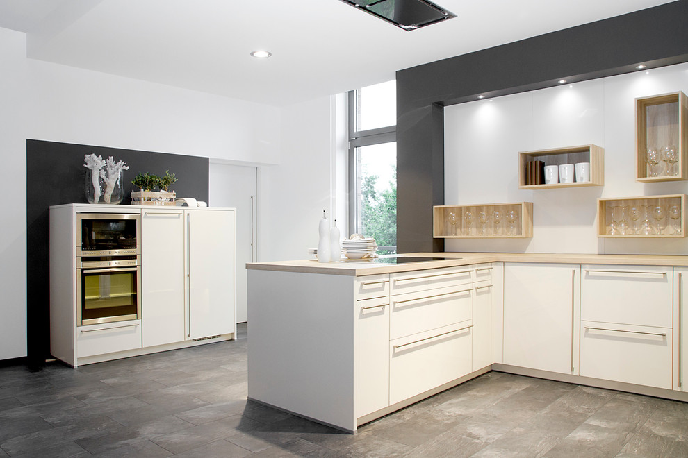 Design ideas for a medium sized modern u-shaped kitchen with an integrated sink, white cabinets, laminate countertops, blue splashback, stone tiled splashback, white appliances and dark hardwood flooring.