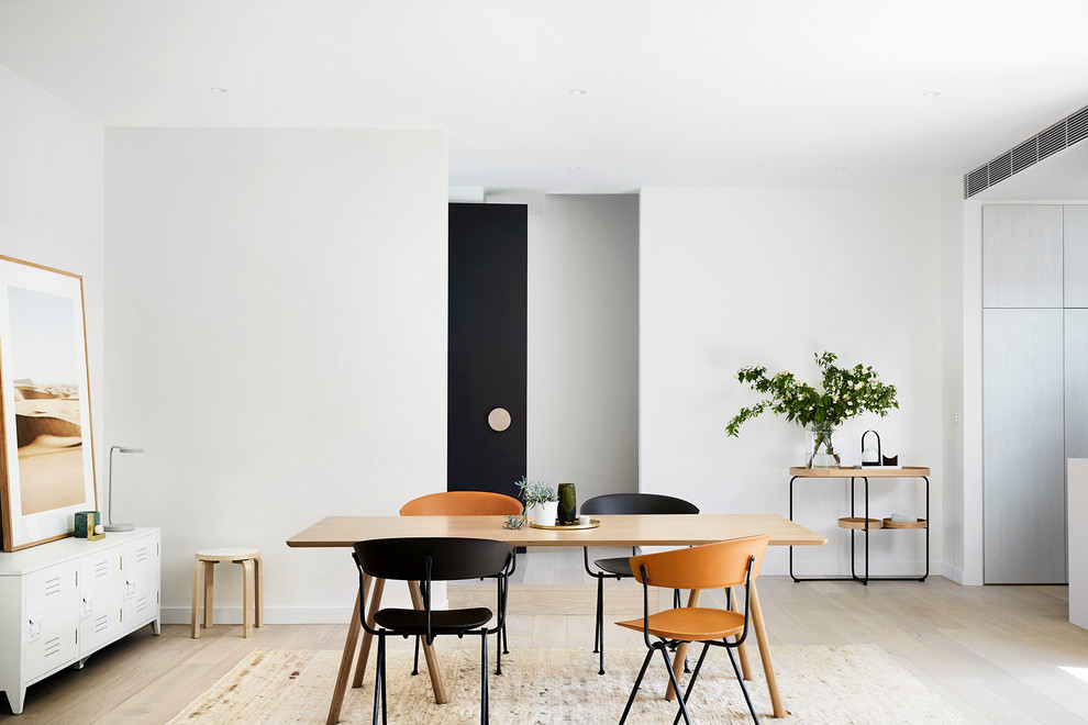 Mid-sized contemporary open plan dining in Melbourne with white walls and light hardwood floors.