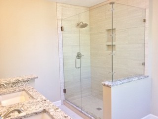 Inspiration for a large transitional master ceramic tile corner shower remodel in Raleigh with a hinged shower door