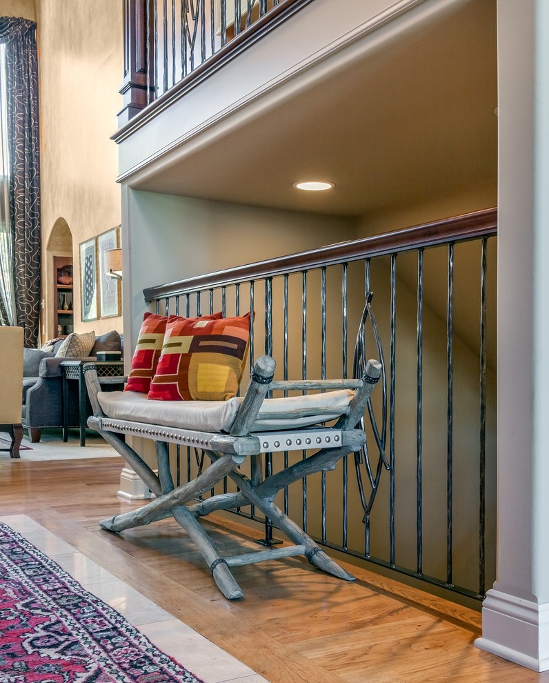 Example of a huge transitional medium tone wood floor foyer design in Omaha with orange walls and a medium wood front door