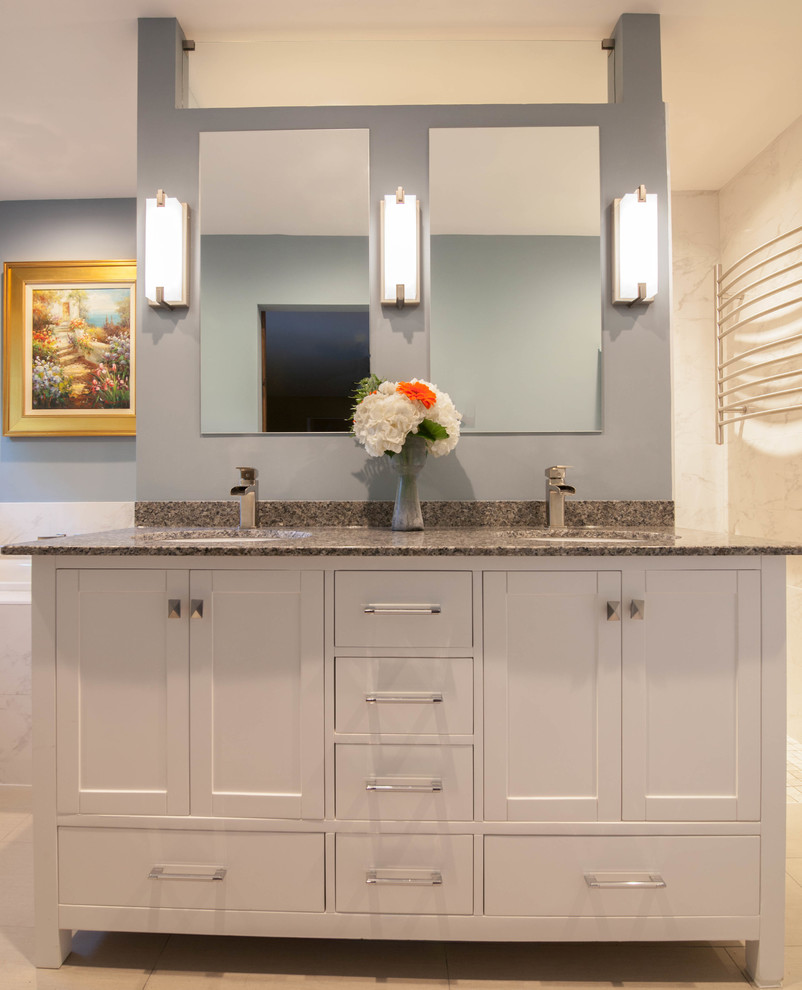 Drop-in bathtub - large transitional master white tile and ceramic tile ceramic tile and beige floor drop-in bathtub idea in Atlanta with shaker cabinets, white cabinets, a one-piece toilet, blue walls, an undermount sink and granite countertops