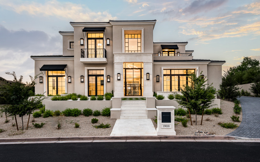 Huge transitional beige two-story stucco house exterior idea in Phoenix with a hip roof, a tile roof and a black roof