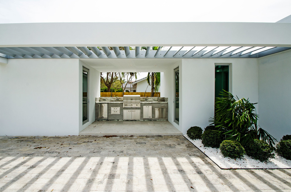 Mid-sized modern backyard patio in Miami with an outdoor kitchen, tile and a pergola.
