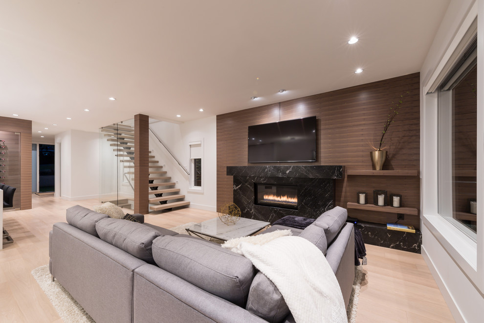 Mid-sized contemporary open concept living room in Vancouver with white walls, light hardwood floors, a ribbon fireplace, a stone fireplace surround and a wall-mounted tv.