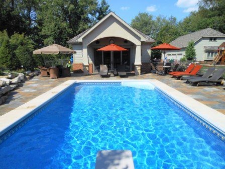 Pool - large transitional backyard stone and rectangular lap pool idea