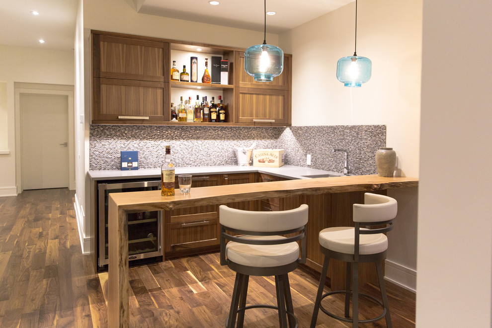 Design ideas for a small transitional u-shaped wet bar in Vancouver with shaker cabinets, medium wood cabinets and wood benchtops.