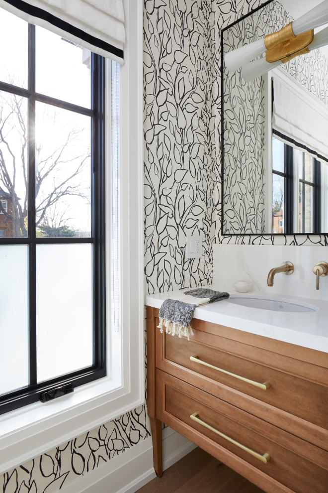 Photo of a mid-sized transitional bathroom in Toronto with shaker cabinets, medium wood cabinets, multi-coloured walls, light hardwood floors, an undermount sink, beige floor, white benchtops, a single vanity and a freestanding vanity.