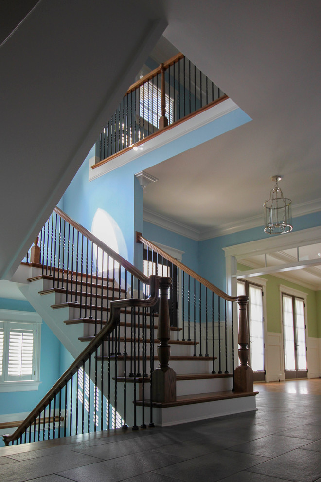 Inspiration for an expansive traditional wood spiral staircase in DC Metro with wood risers and metal railing.