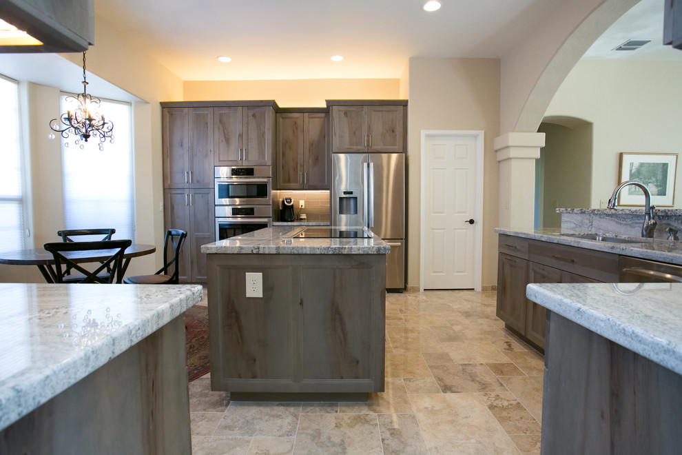 Eat-in kitchen - small rustic l-shaped ceramic tile eat-in kitchen idea in Phoenix with an undermount sink, flat-panel cabinets, gray cabinets, granite countertops, gray backsplash, ceramic backsplash, stainless steel appliances and an island