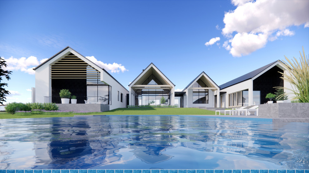 Foto di una grande piscina a sfioro infinito minimal rettangolare dietro casa con paesaggistica bordo piscina e pavimentazioni in pietra naturale
