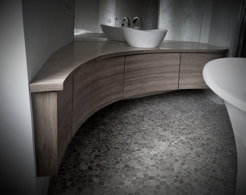 Inspiration for a contemporary master bathroom in Rome with beaded inset cabinets, light wood cabinets, a freestanding tub, a curbless shower, a wall-mount toilet, white tile, pebble tile, pebble tile floors, a vessel sink, wood benchtops, a hinged shower door, a single vanity and a floating vanity.