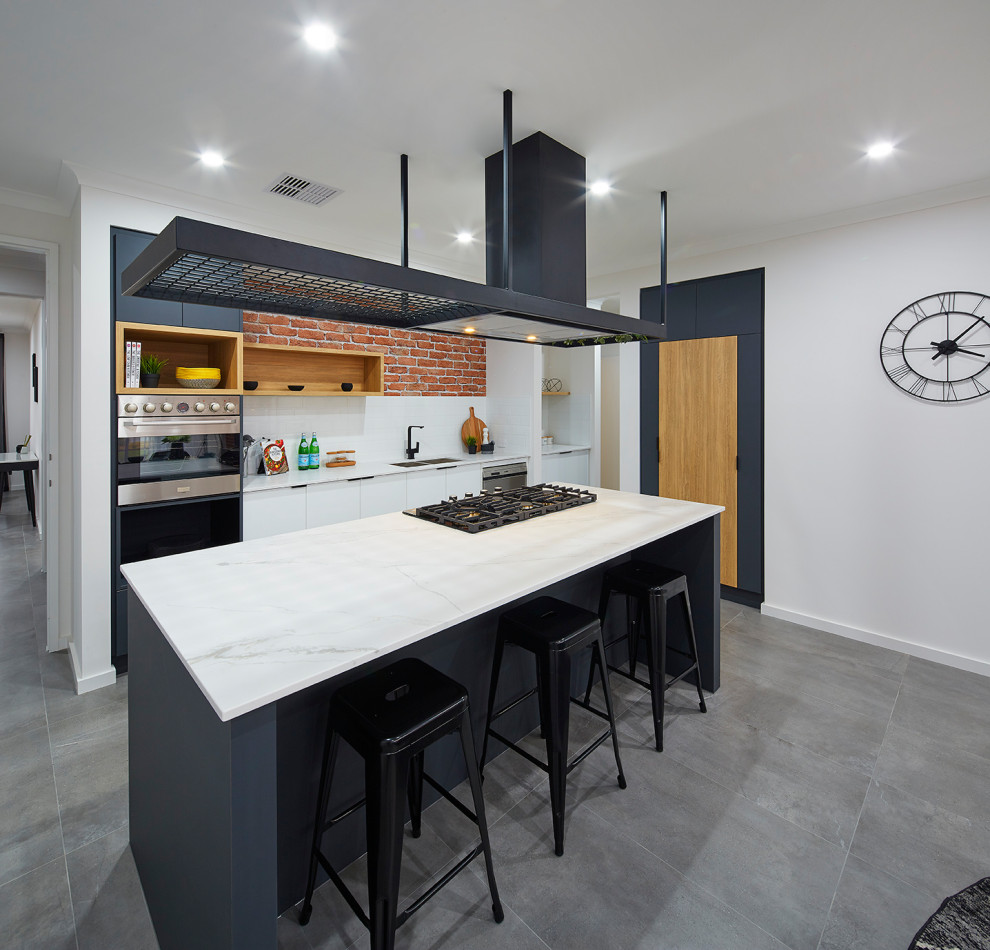 Inspiration for a contemporary galley kitchen in Perth with an undermount sink, flat-panel cabinets, white cabinets, stainless steel appliances, with island, grey floor and white benchtop.