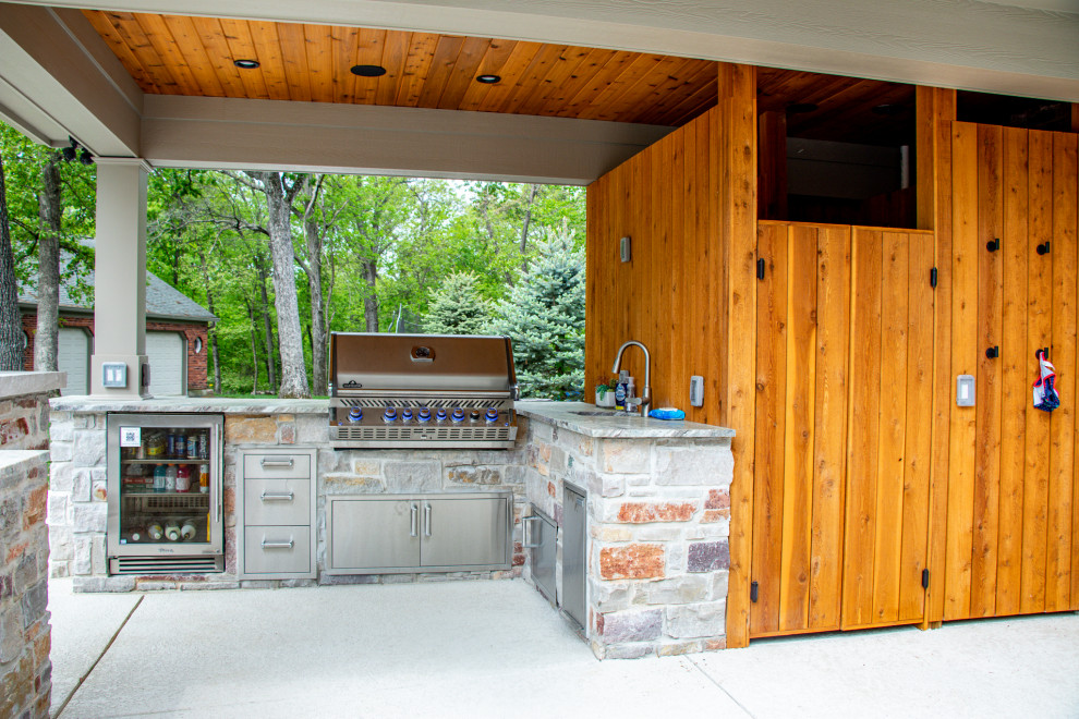 Covered Patio with an Outdoor Kitchen area and Fireplace Area Patio