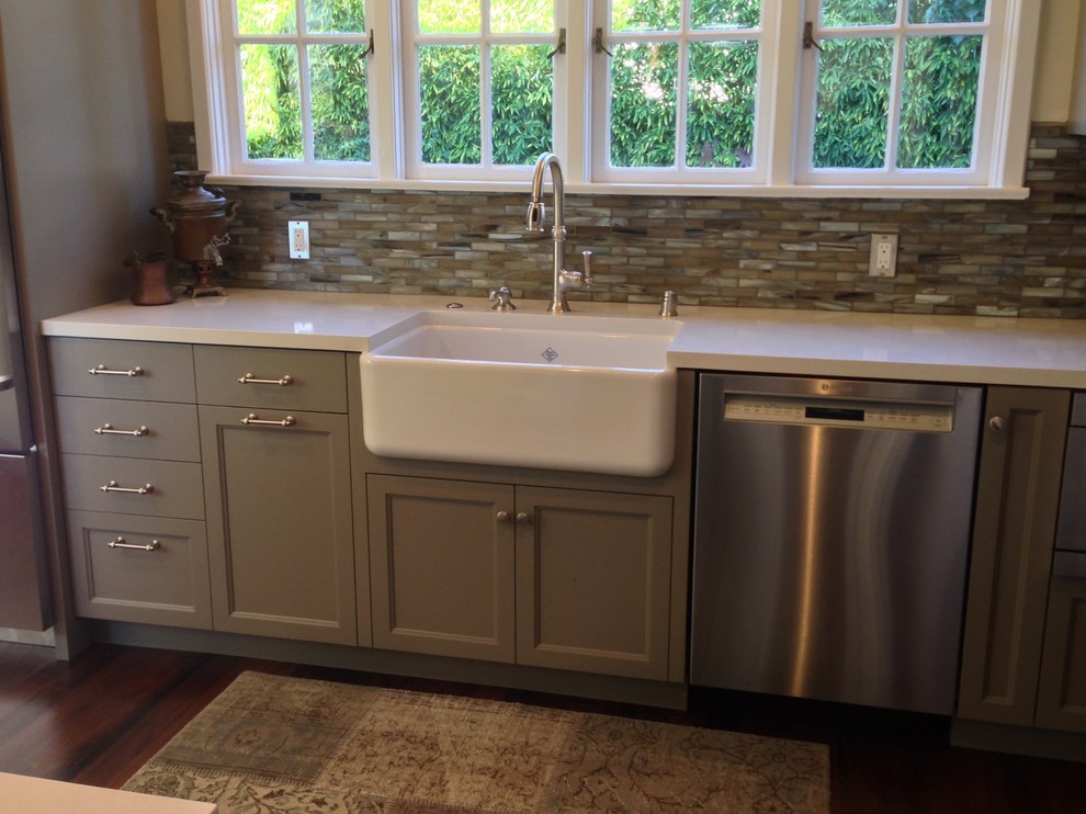 Mid-sized country galley eat-in kitchen in San Francisco with a farmhouse sink, shaker cabinets, grey cabinets, quartz benchtops, multi-coloured splashback, mosaic tile splashback, stainless steel appliances, medium hardwood floors, no island, brown floor and white benchtop.