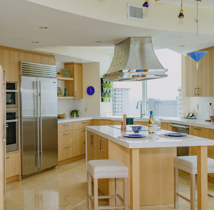 Example of a mid-sized transitional u-shaped porcelain tile and beige floor open concept kitchen design in Miami with an undermount sink, flat-panel cabinets, light wood cabinets, quartz countertops, white backsplash, stainless steel appliances, an island and white countertops
