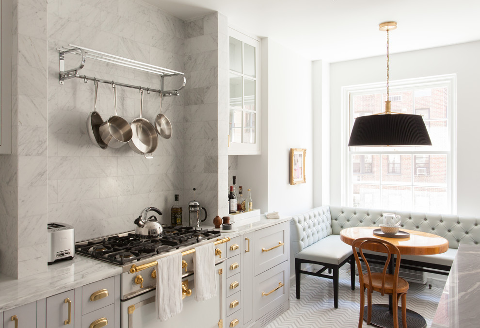 Traditional single-wall eat-in kitchen in New York with an undermount sink, flat-panel cabinets, grey cabinets, marble benchtops, grey splashback, stone tile splashback, white appliances, porcelain floors and no island.