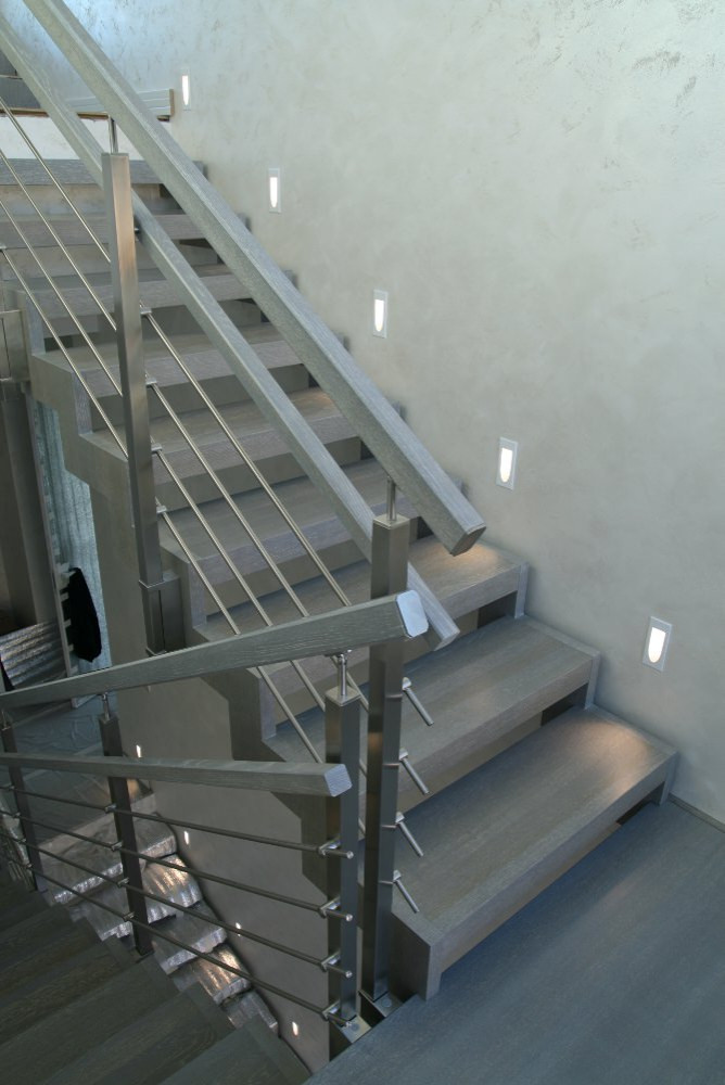 Modern metal stair covered by patina oak