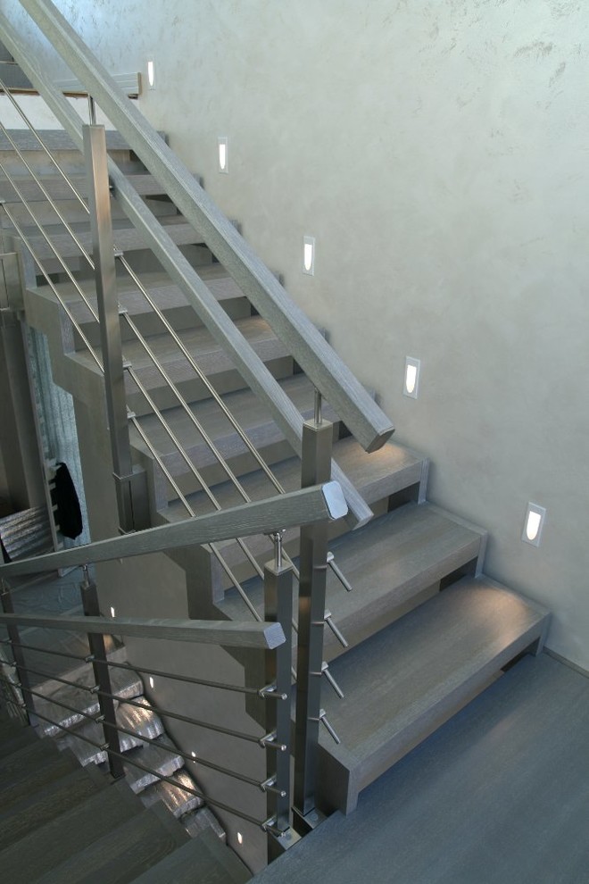 Modern metal stair covered by patina oak