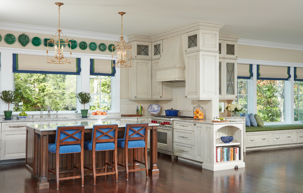Inspiration for a beach style l-shaped kitchen in Baltimore with raised-panel cabinets, beige cabinets, window splashback, stainless steel appliances, medium hardwood floors and with island.
