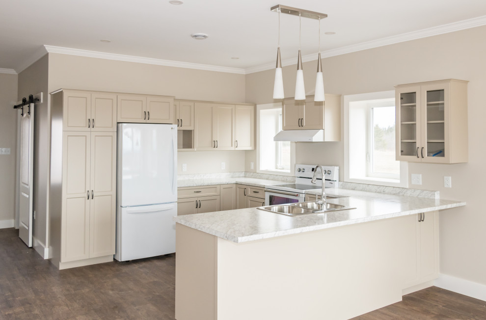 Inspiration for a mid-sized u-shaped vinyl floor and brown floor kitchen remodel with a drop-in sink, recessed-panel cabinets, beige cabinets, laminate countertops, white appliances and white countertops
