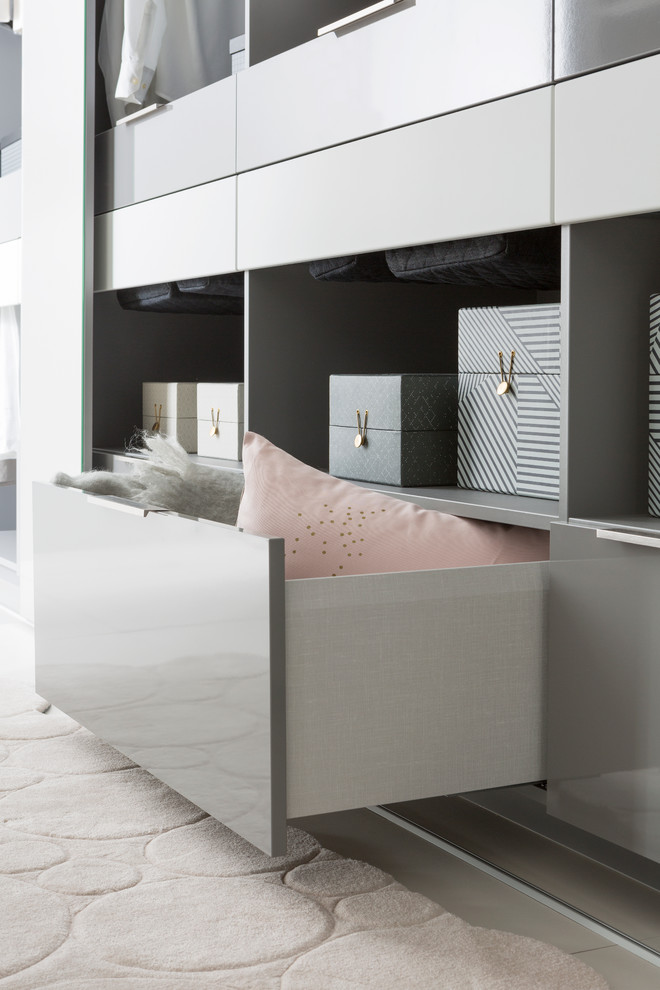 Design ideas for a large contemporary gender-neutral dressing room in Lyon with open cabinets and grey cabinets.