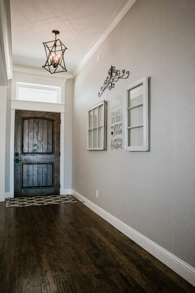 Mid-sized country foyer in Dallas with grey walls, dark hardwood floors, a single front door, a dark wood front door and brown floor.