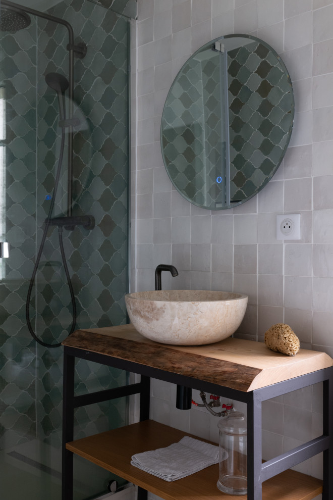 Small mediterranean shower room bathroom in Paris with a one-piece toilet, green tiles, green walls, light hardwood flooring, a built-in sink, wooden worktops, a sliding door, a wall niche and a single sink.