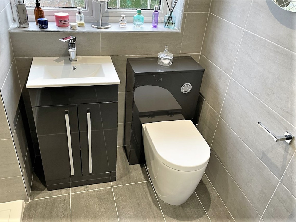 Exempel på ett mellanstort modernt badrum för barn, med släta luckor, grå skåp, en öppen dusch, en toalettstol med hel cisternkåpa, grå kakel, porslinskakel, klinkergolv i porslin, ett nedsänkt handfat och grått golv